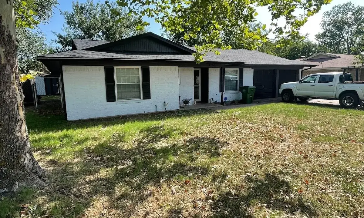 Professional roofing crew working on a residential roof in Moody